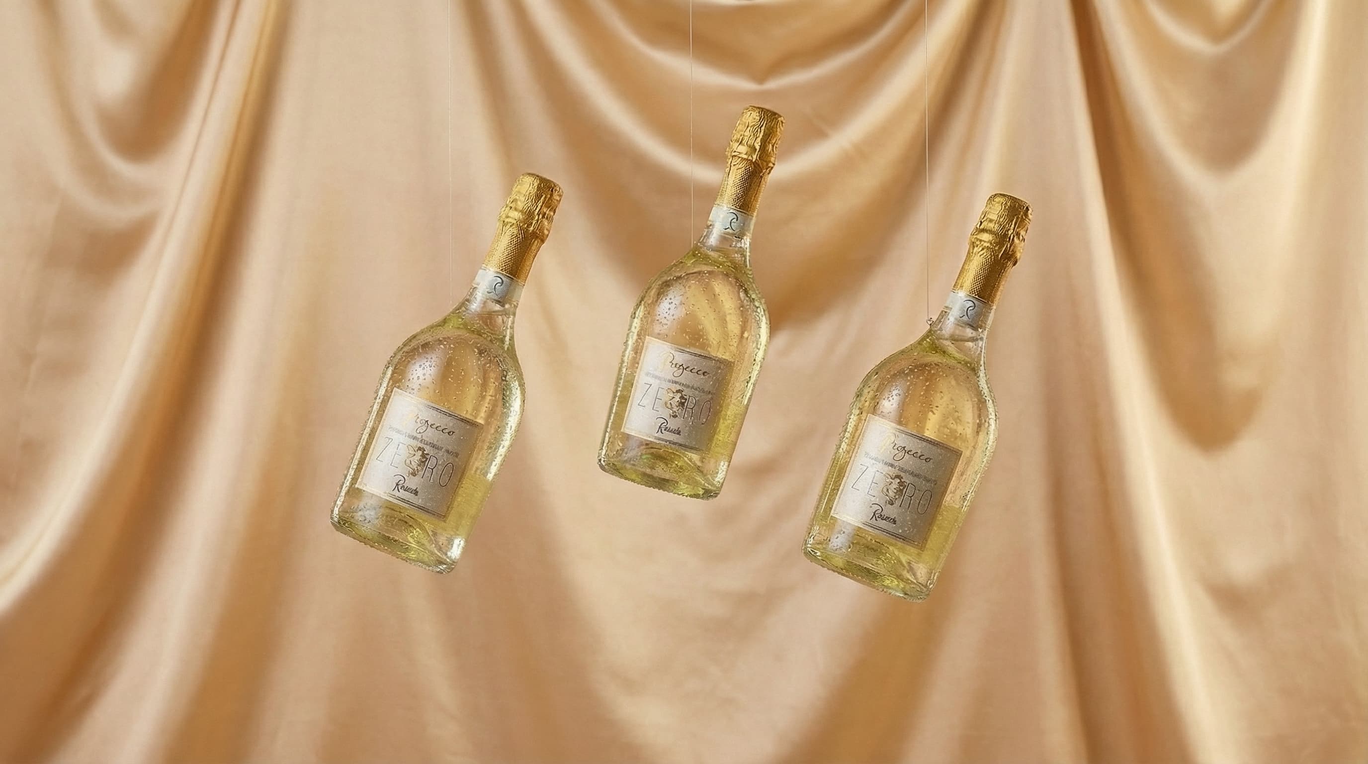 Prosecco Zero Brut — three bottles on gold satin